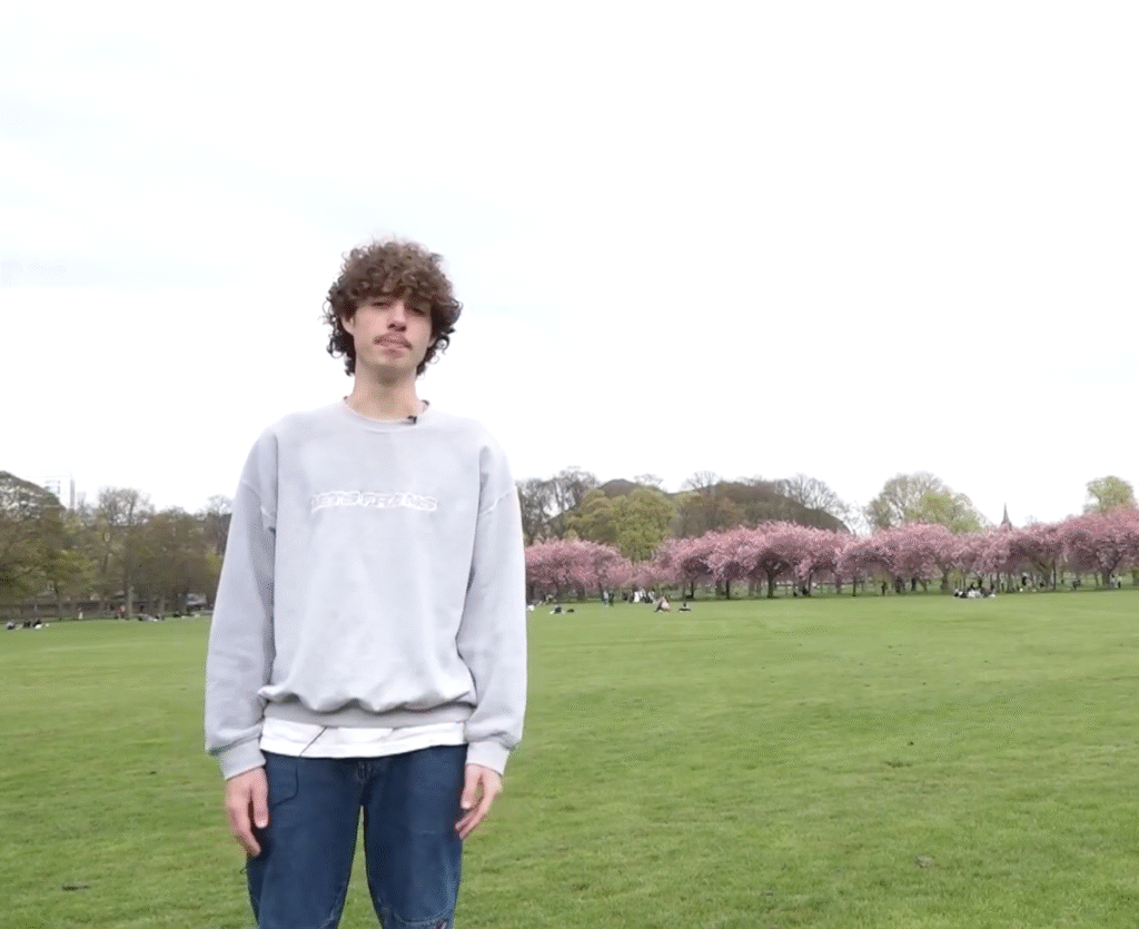 Matthew presenting a piece to camera in the Meadows